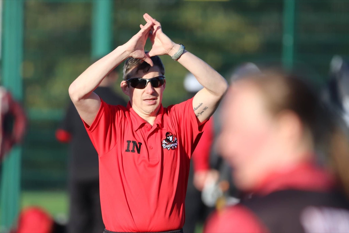 Ian Nicolson coaching an athlete on the field